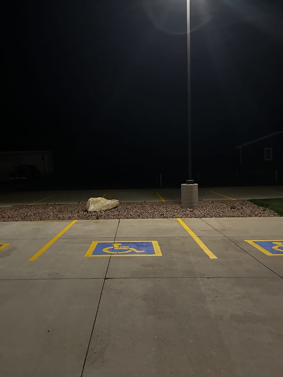 Accessible parking stalls striped at night.