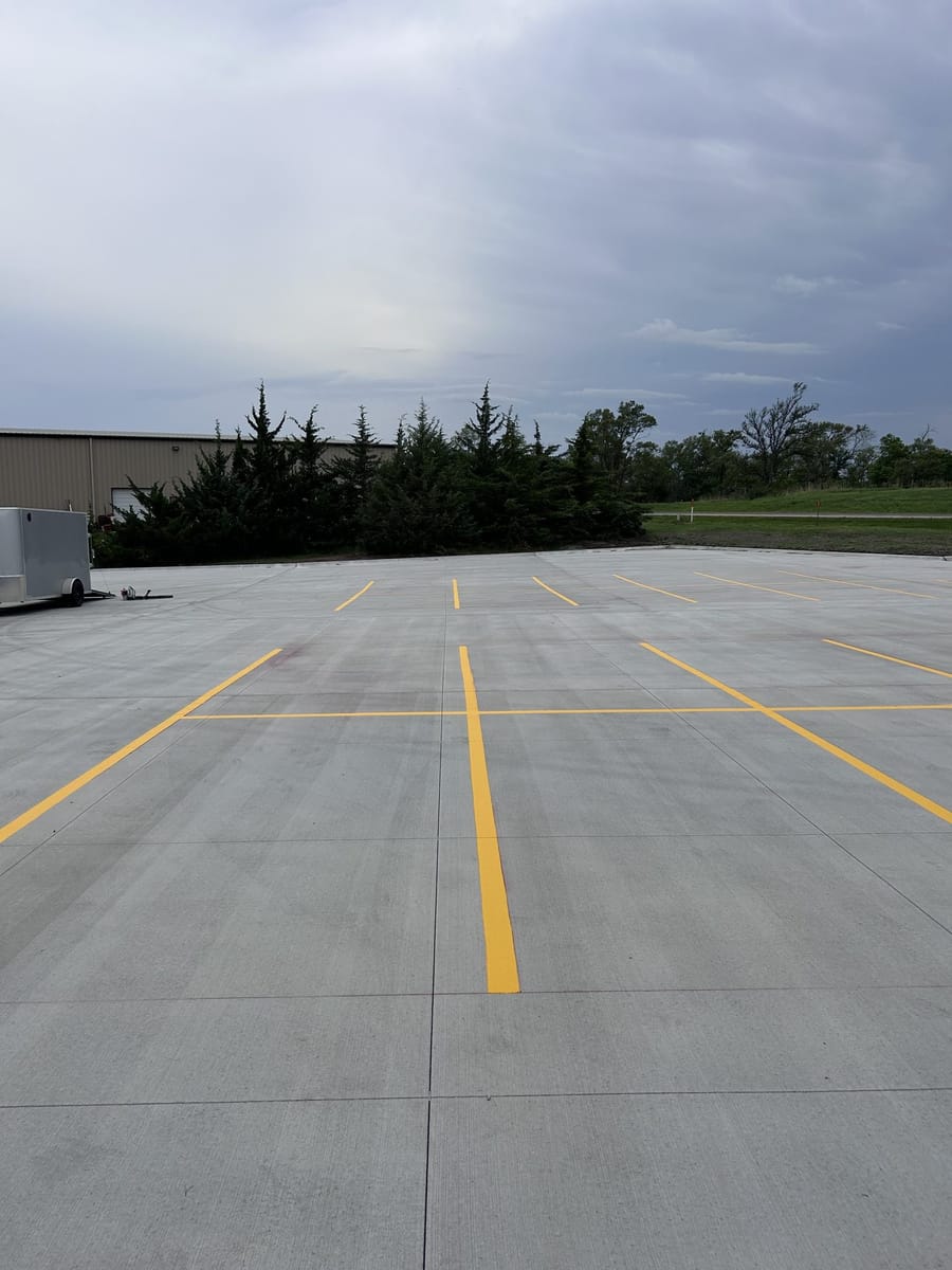 Fresh yellow parking lines on new concrete.