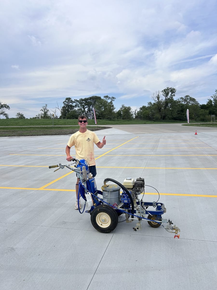 Karter with the line striper on a freshly marked lot.